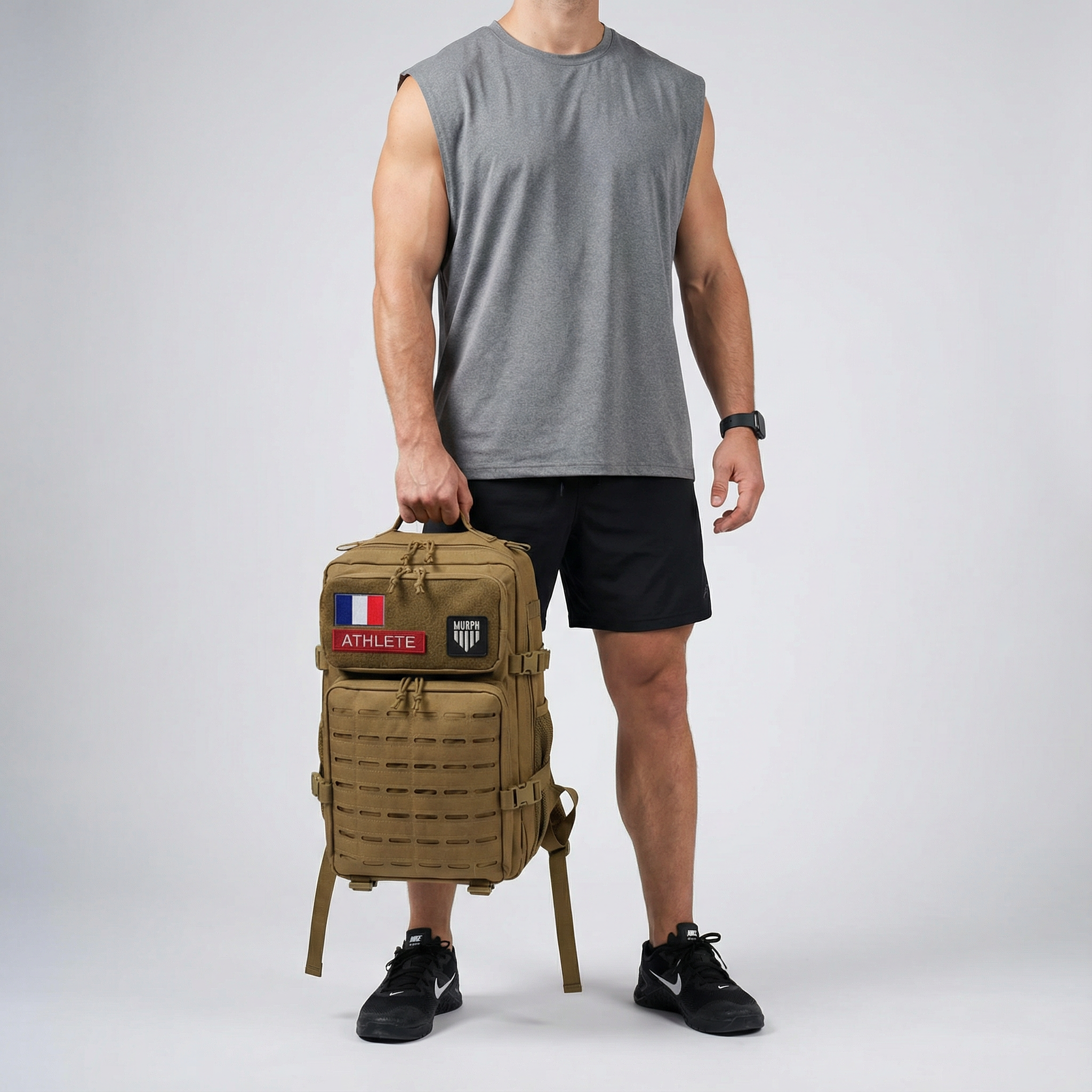 Sac à Dos CrossFit 45L Marron Hero Murph - Athlète Homme Tenant le Sac à la Main
